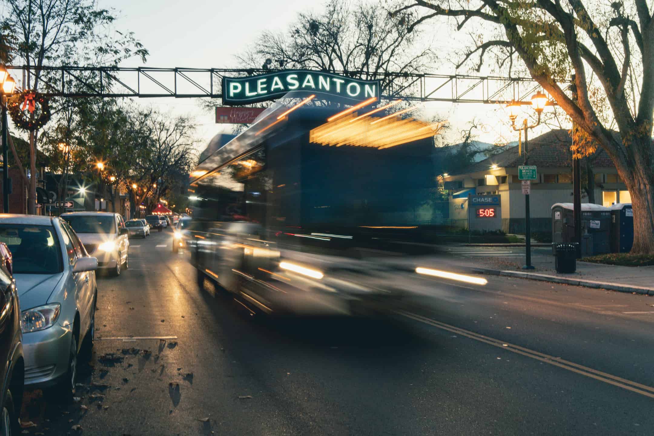 Wheels bus in motion in Pleaseanton night intersection