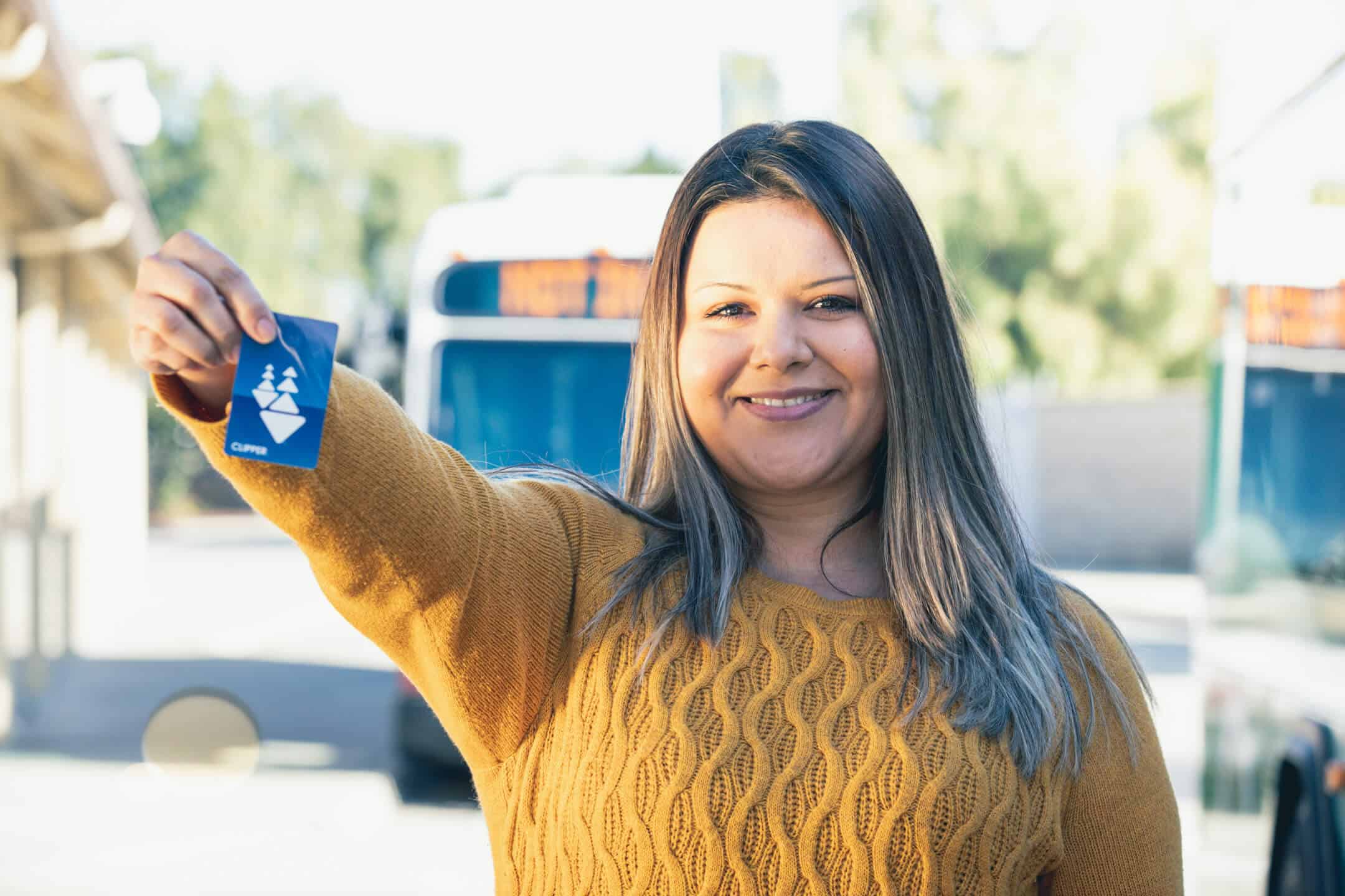 Woman holding Clipper card arm extended